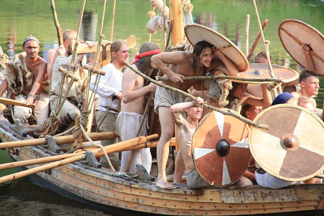 people in a boat with round instruments on the water