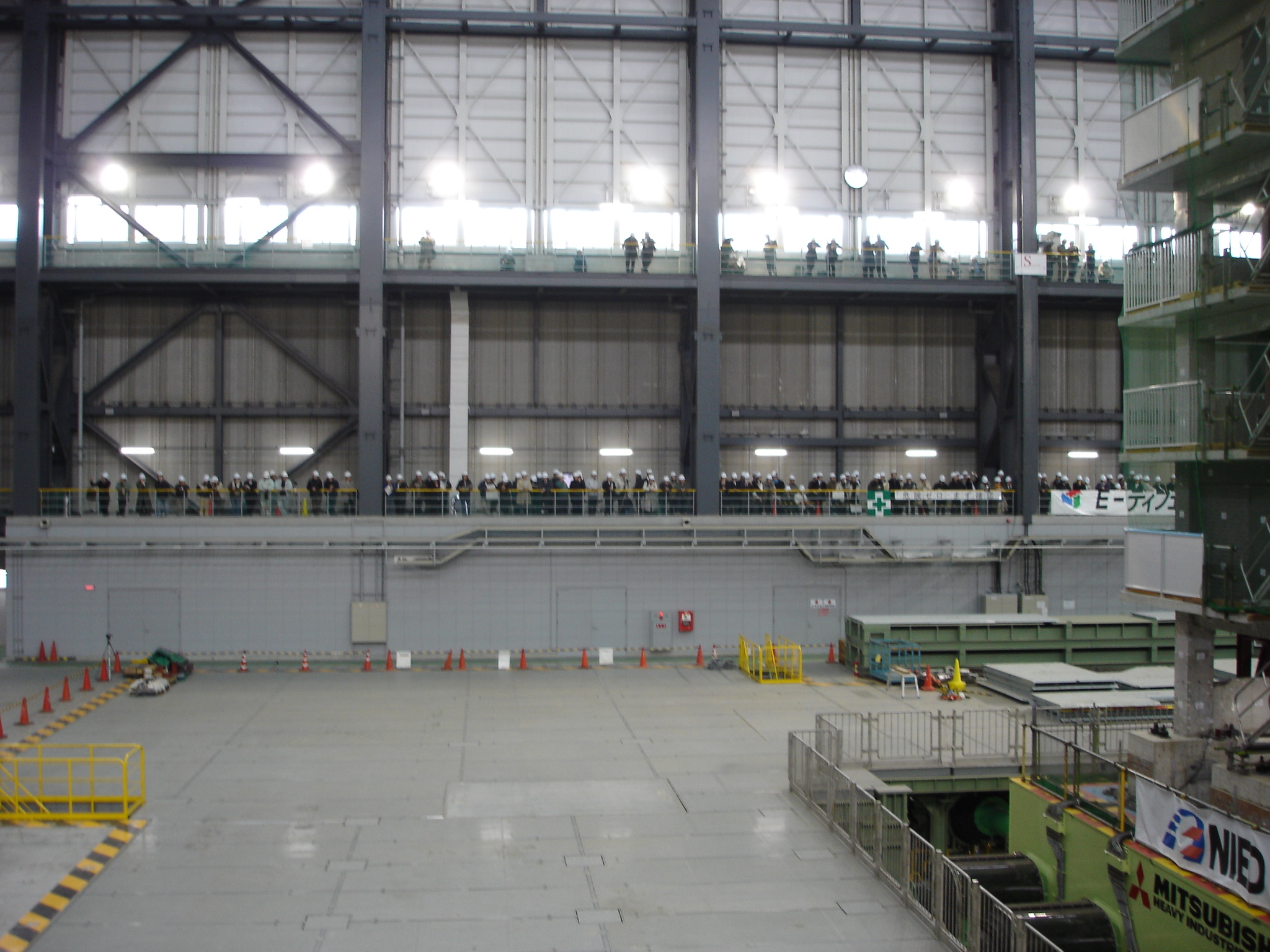 an inside view of a large warehouse with lots of people