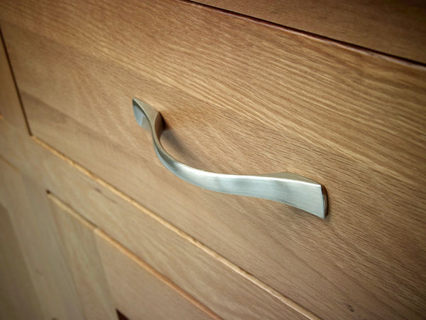 a close up of a dresser drawer with the handle on it