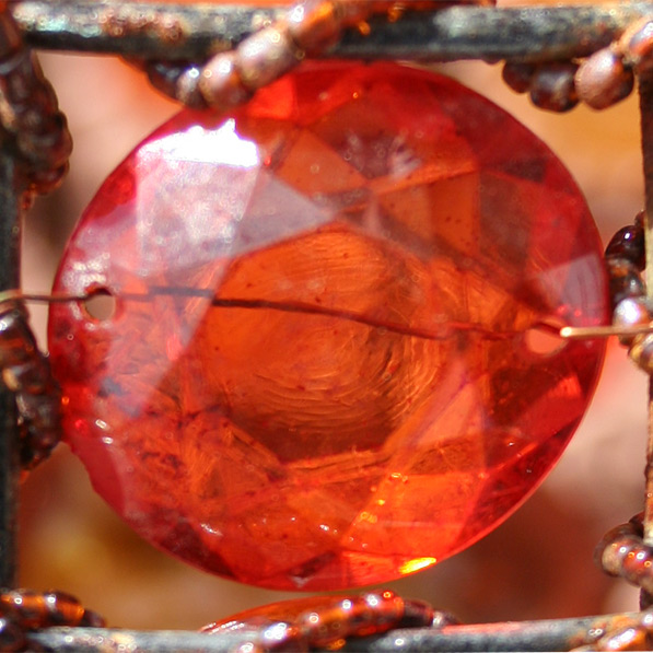 a red gems set in wire and metal