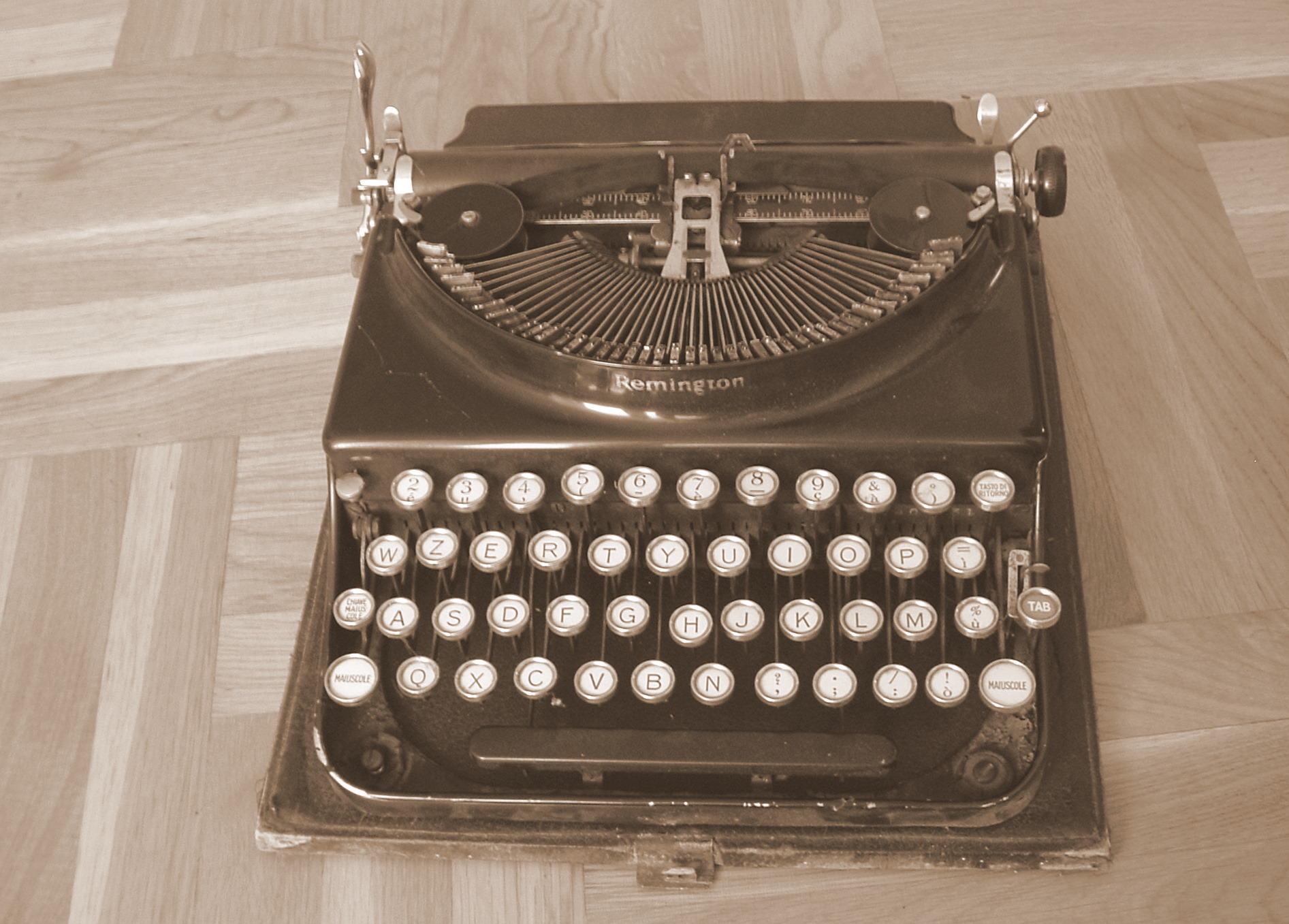 an old fashioned black and white typewriter on the floor