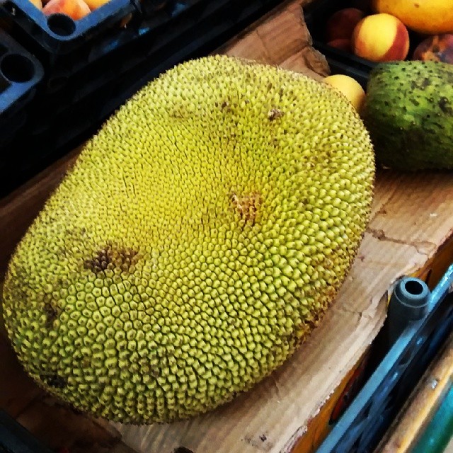 a jacked out papayas on a wooden tray with other fruit