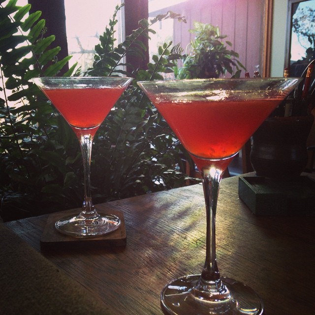 two glasses full of a red drink on a table