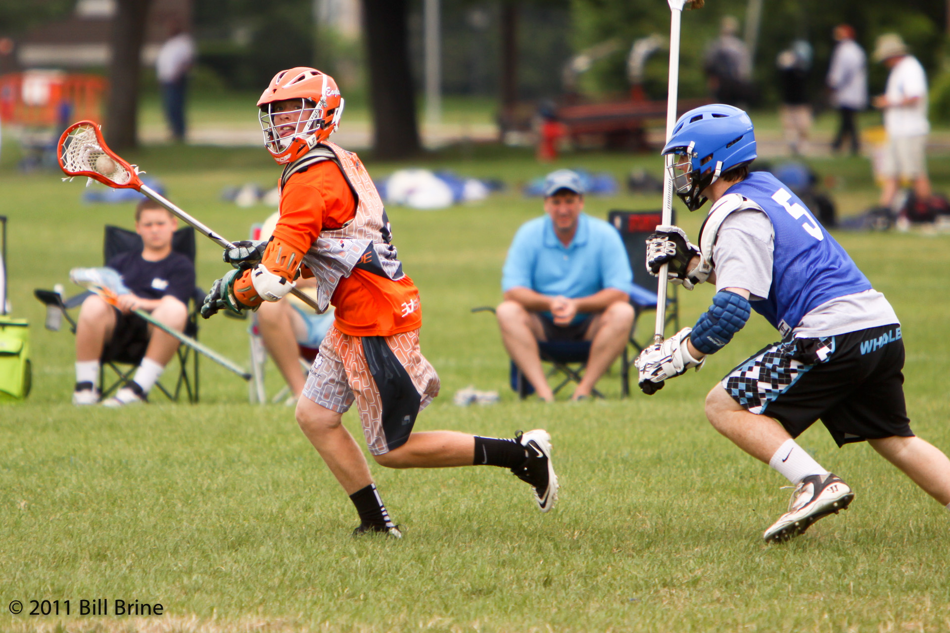 a lacrosse game with several players on the field