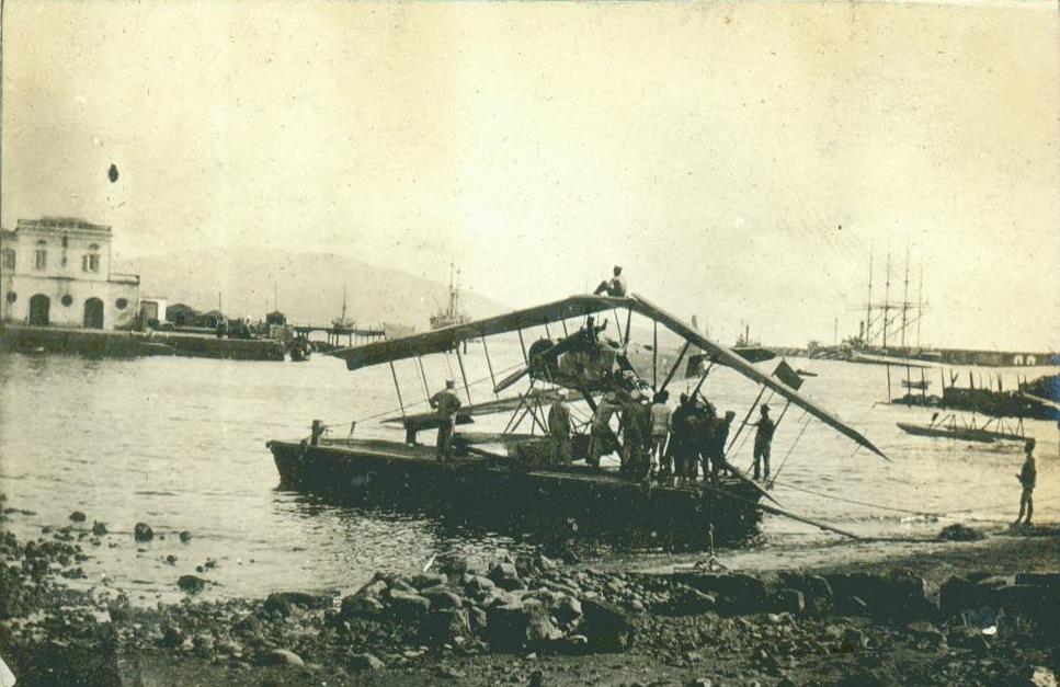 a small boat on the water with people near by