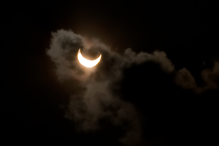 the solar eclipse in a cloud, during a partial solar eclipse
