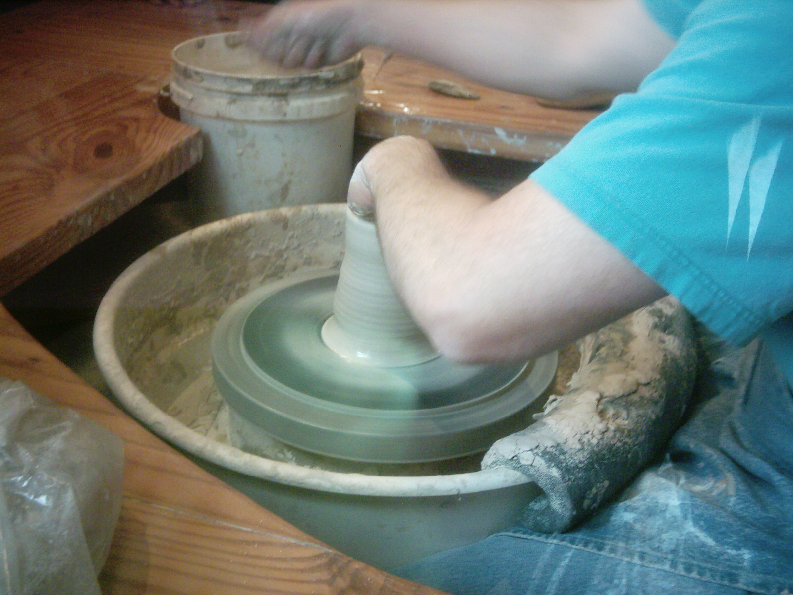 a person spinning on a potter's wheel on a potters wheel