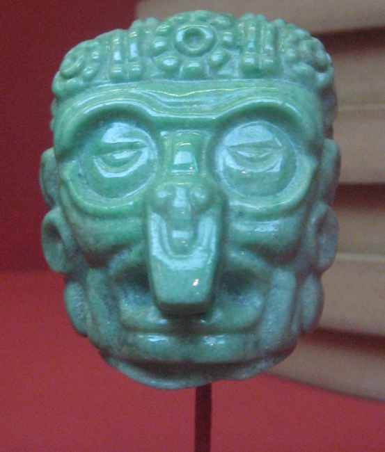 a green head figurine with eyes and nose