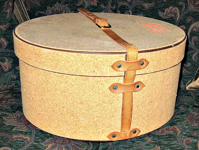 an old - fashioned suitcase is sitting on the floor