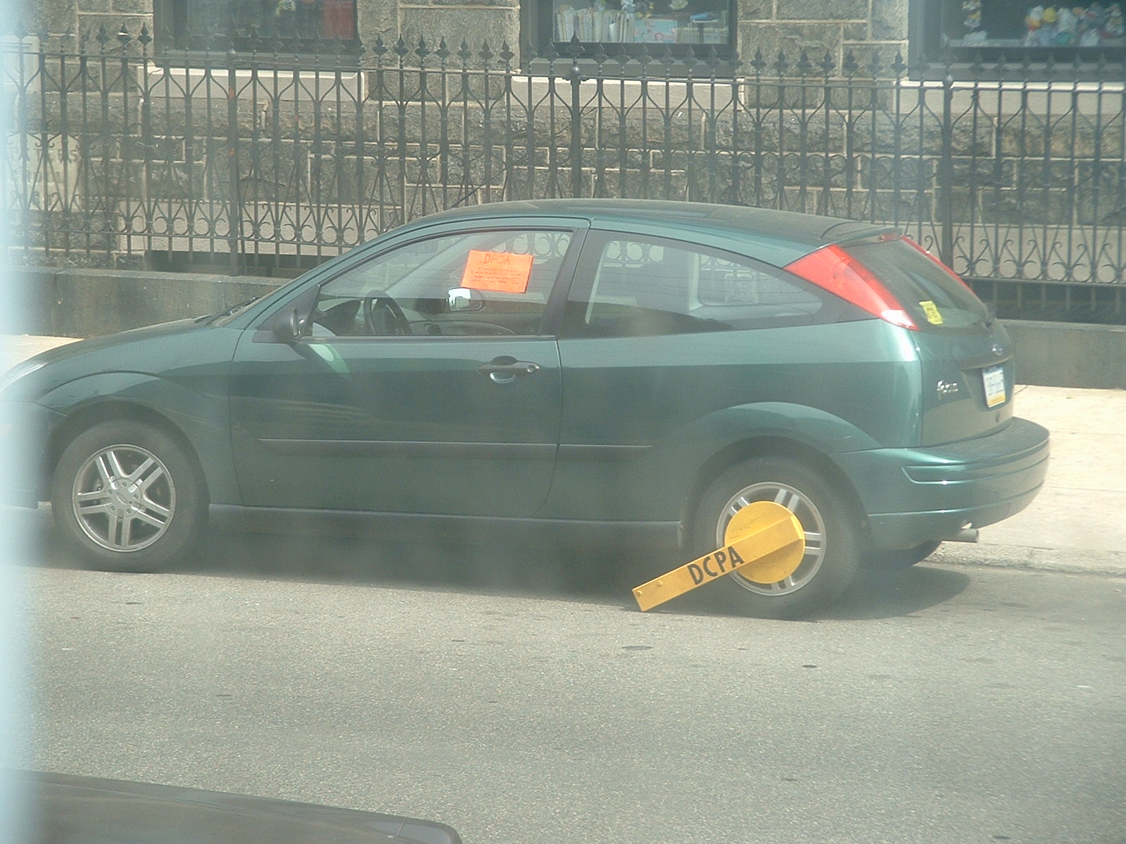 a car with its doors open sitting in the street