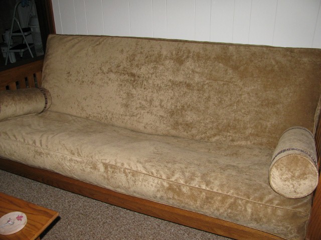 a brown couch in the corner of a living room