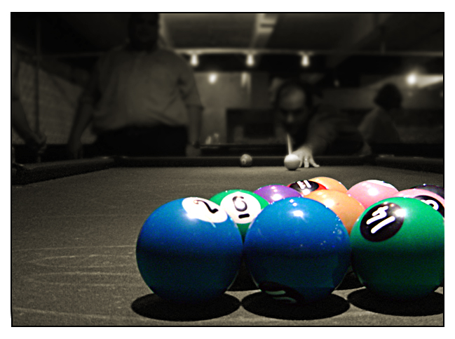 a row of pool balls and one in between