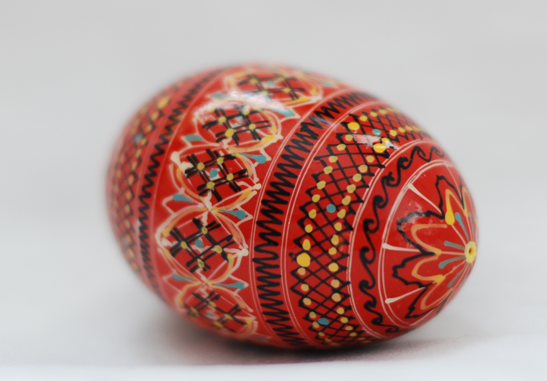 an artisticly designed red ball with designs on it