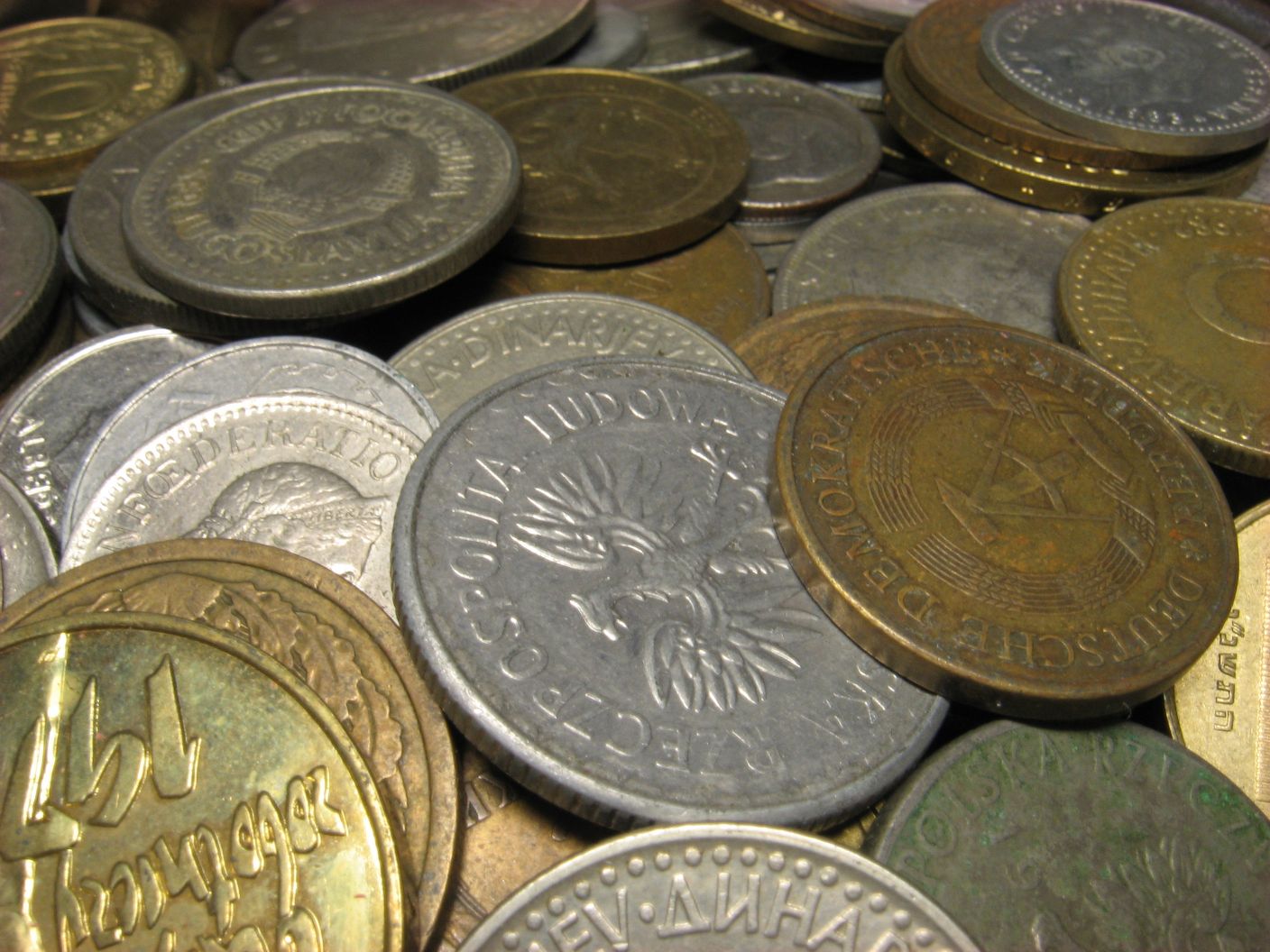 a pile of gold and silver coins on top of each other