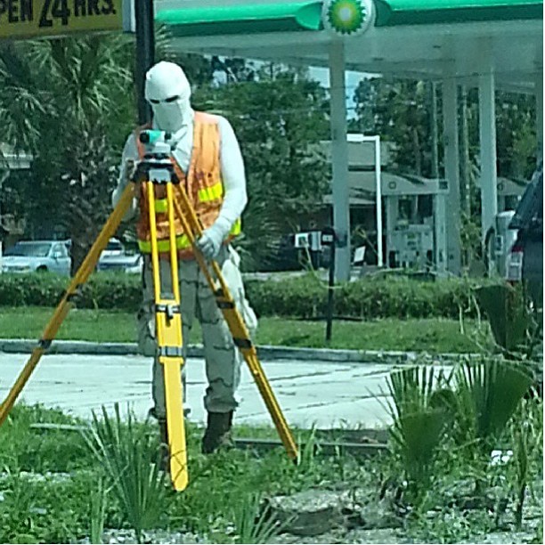 worker fixing the broken fire hydrant at a gas station