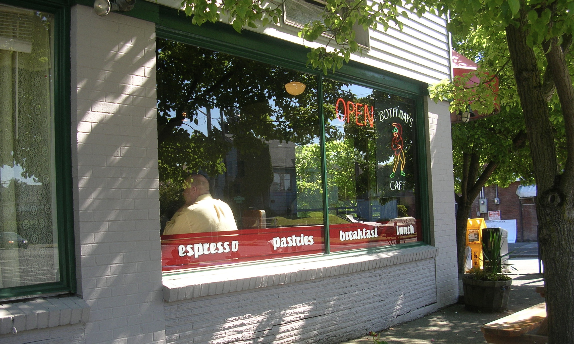 the reflection of two people in the window of a store