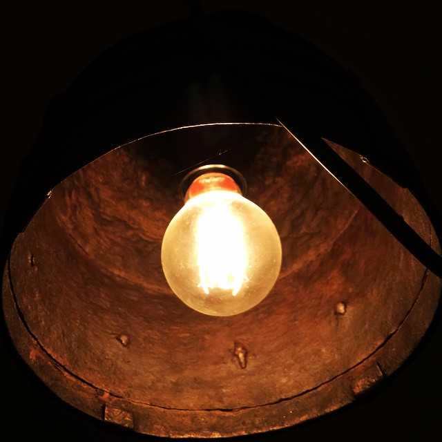 a lit up light bulb in the middle of a room