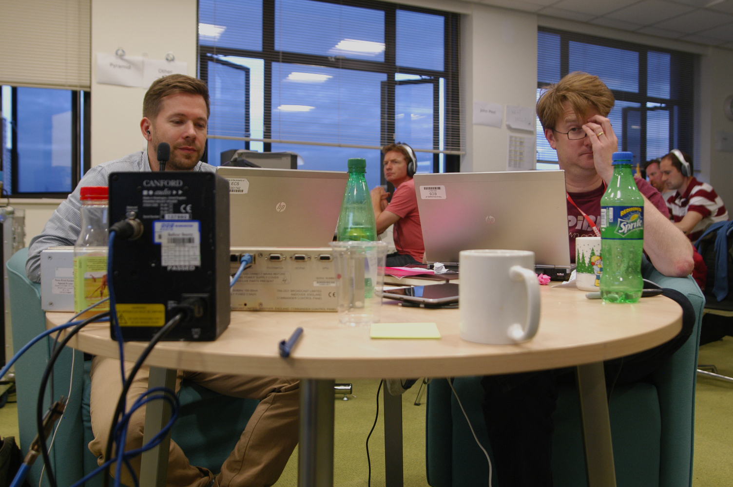 a couple of people sitting in front of laptop computers