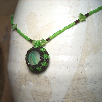 a necklace with an object made out of glass