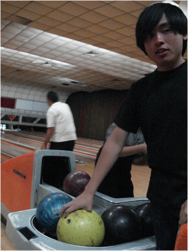 a man holding a bowling ball in his hand