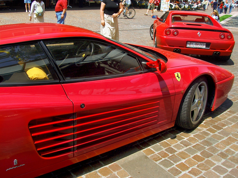 a group of ferraris parked in front of other ferrari cars