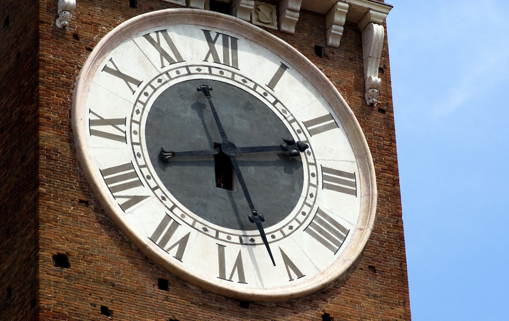 an image of a roman numeral clock face on a brick building