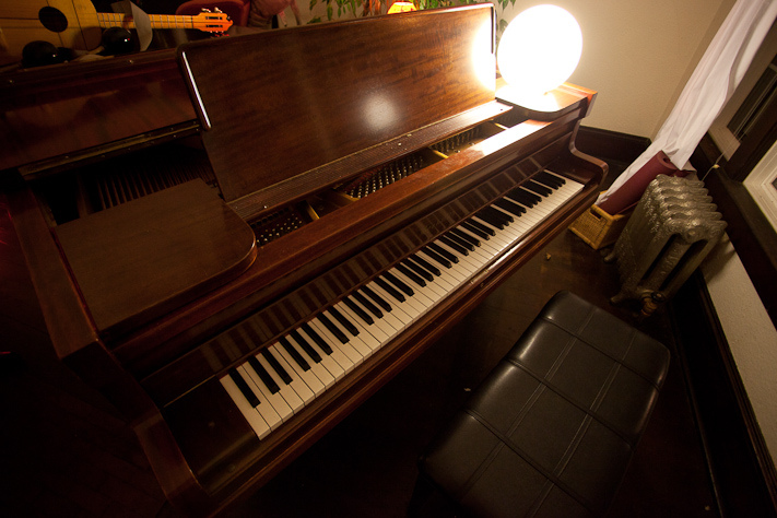 a large open piano in the living room