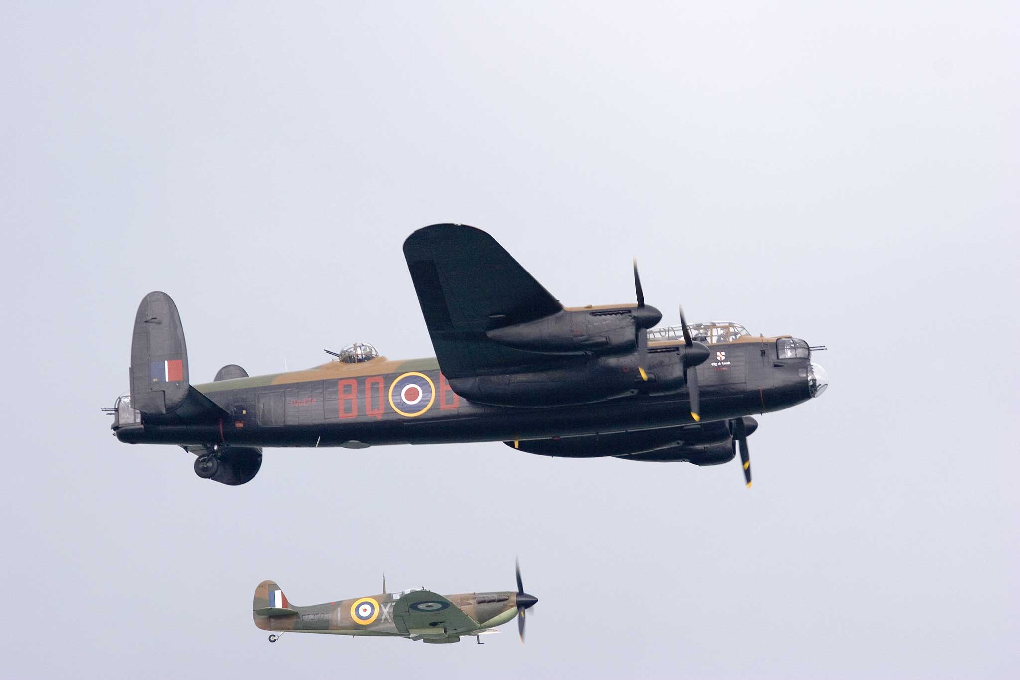 a couple of old fashioned military airplanes flying together