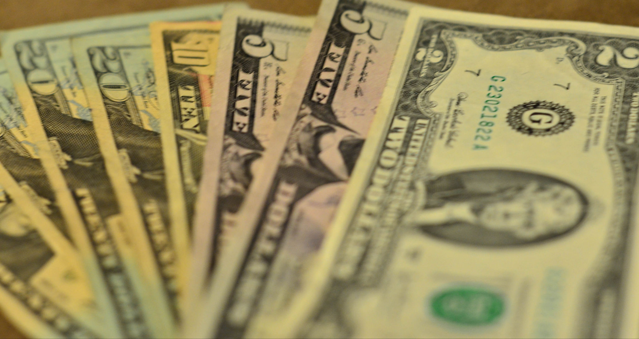 several ten dollar bills spread out on the table