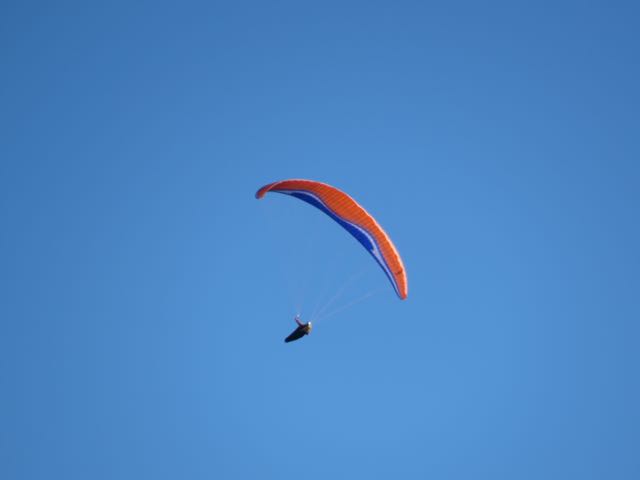 a parasailer is being held out by the strings