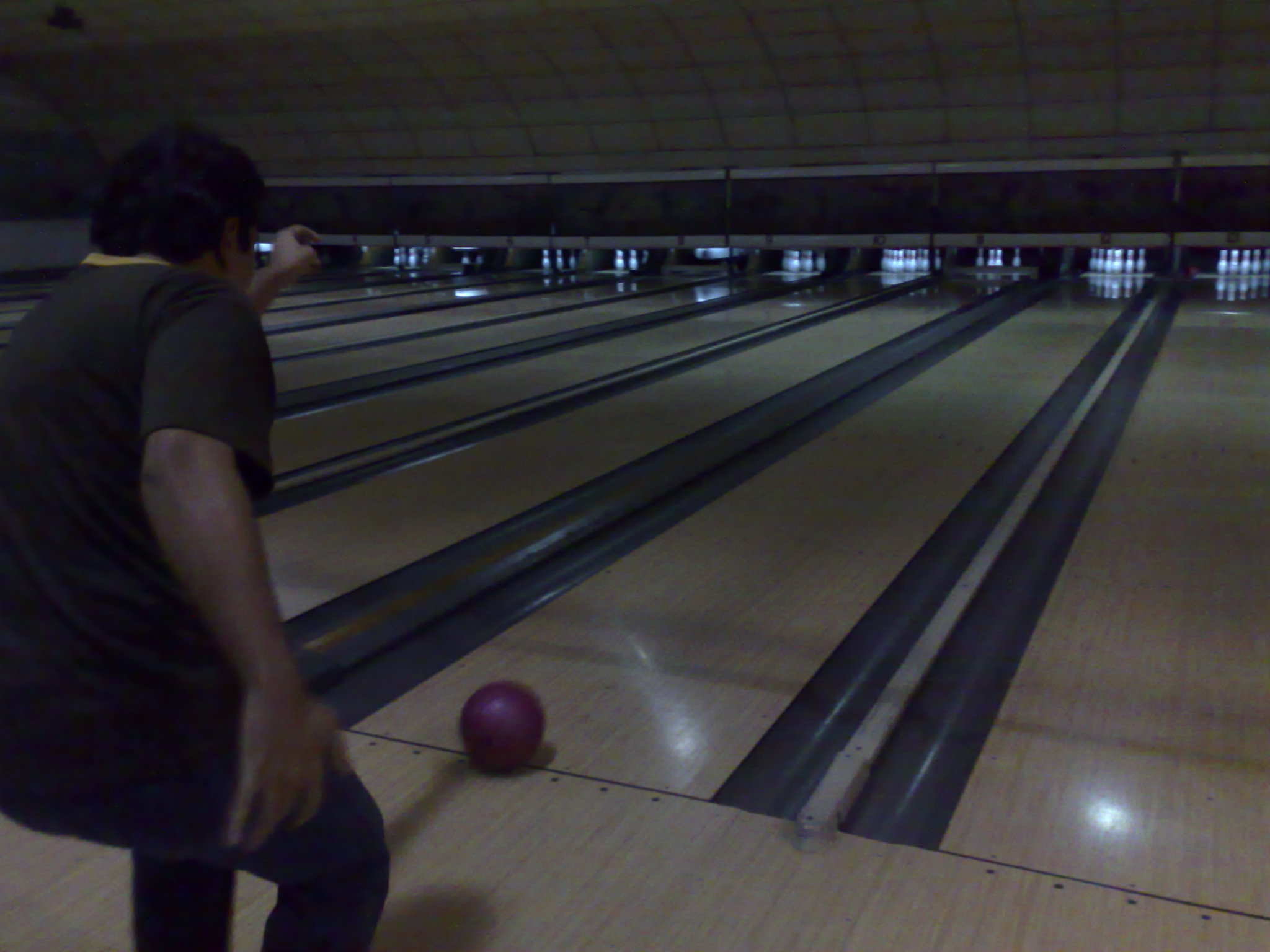 a young man playing a game of bowling
