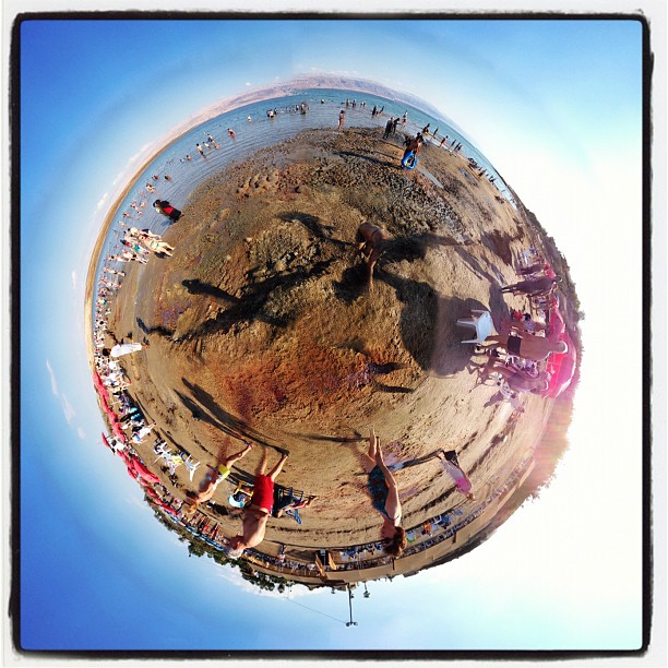 people in the sand at a small group park