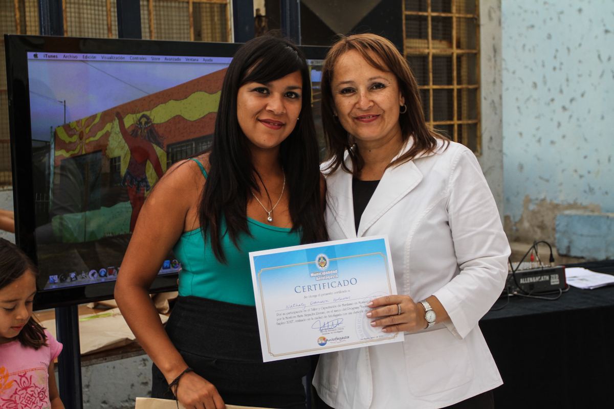 the woman is showing off her award certificate to a friend