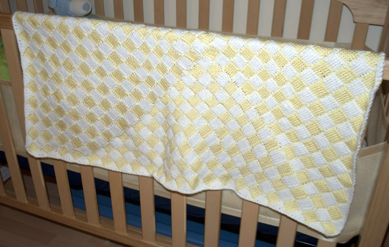 the blanket on top of the crib is yellow
