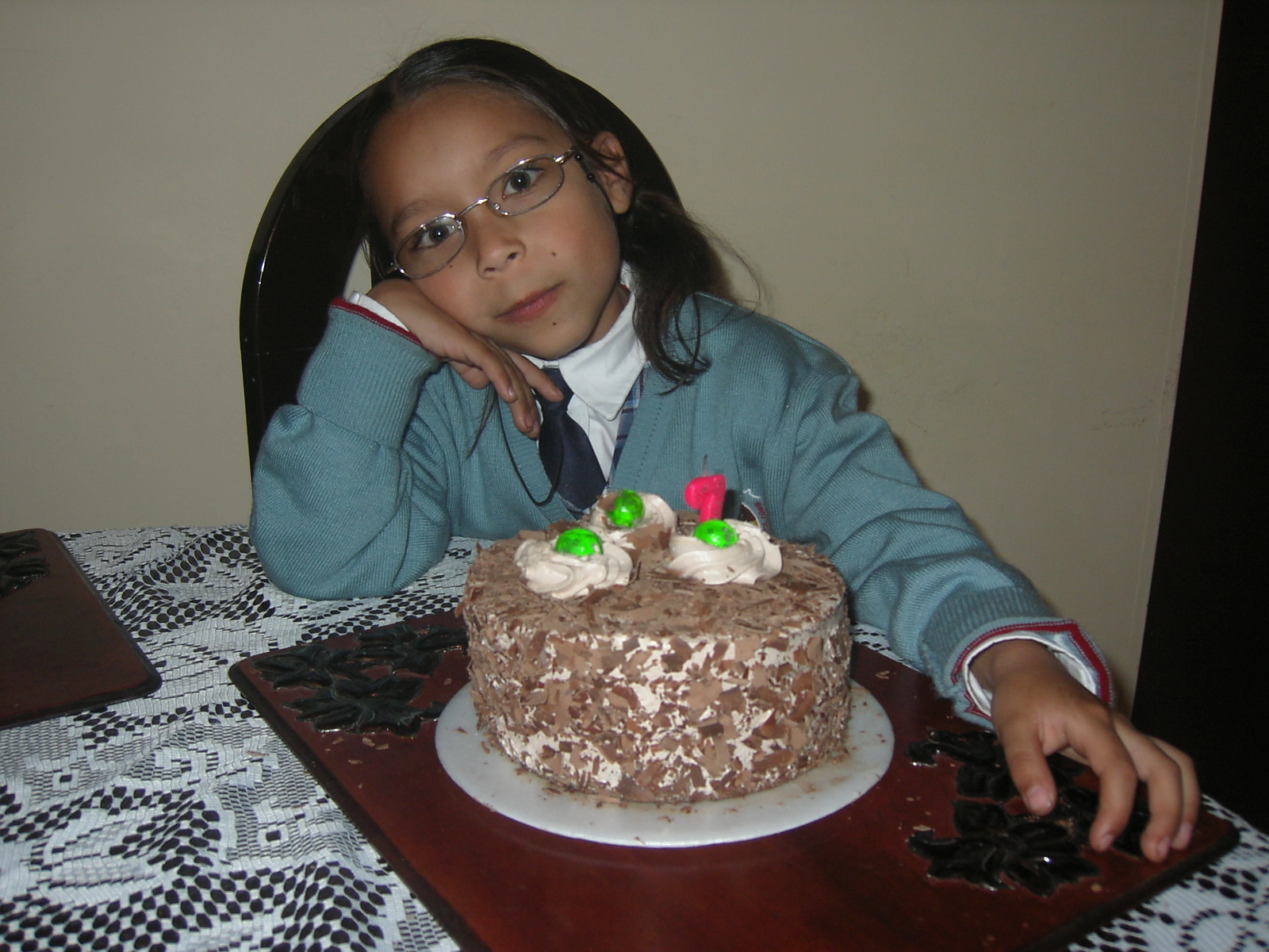  looking at decorated birthday cake sitting on table