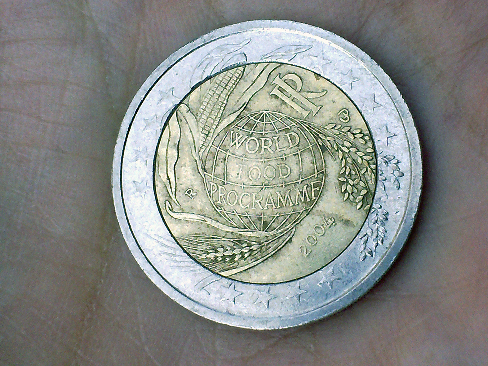 a person is holding a coin with an image on it