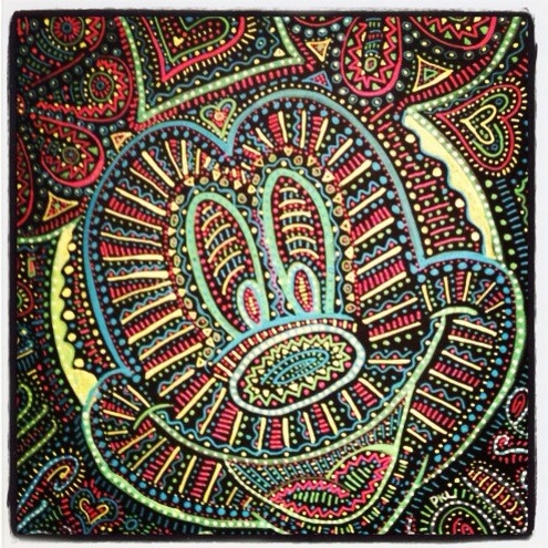 a colorful painting of hamsa hand on display