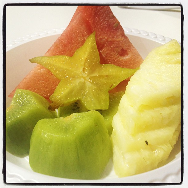 a cut up fruit on a white plate