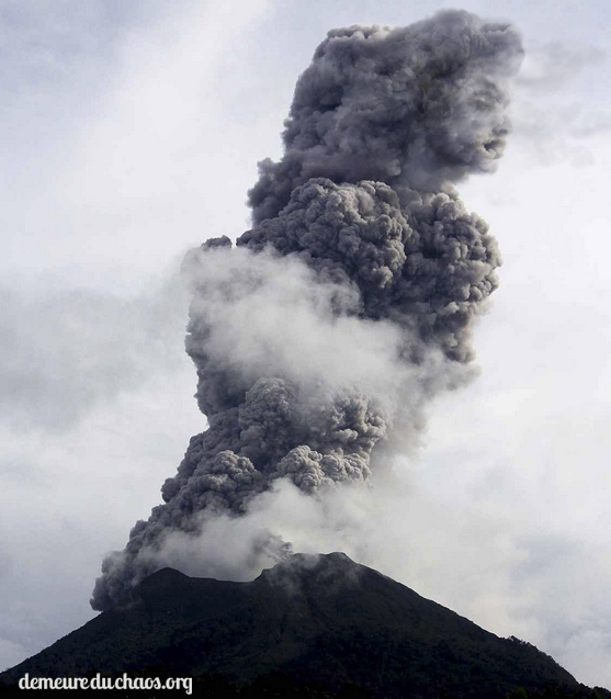 a cloud of smoke billowing from the volcano