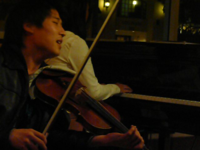 a man is playing the violin outside