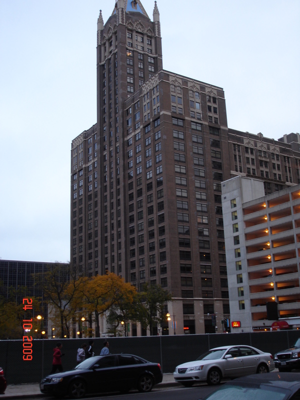 two tall buildings in the city are next to each other