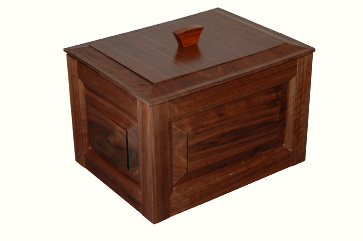a wooden box that has a wood object on top