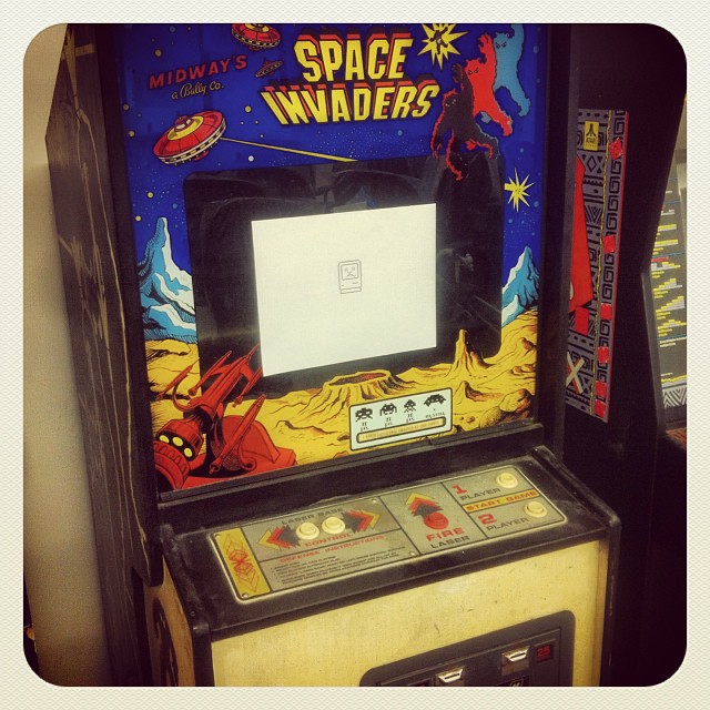 an old fashioned slot machine showing space invades