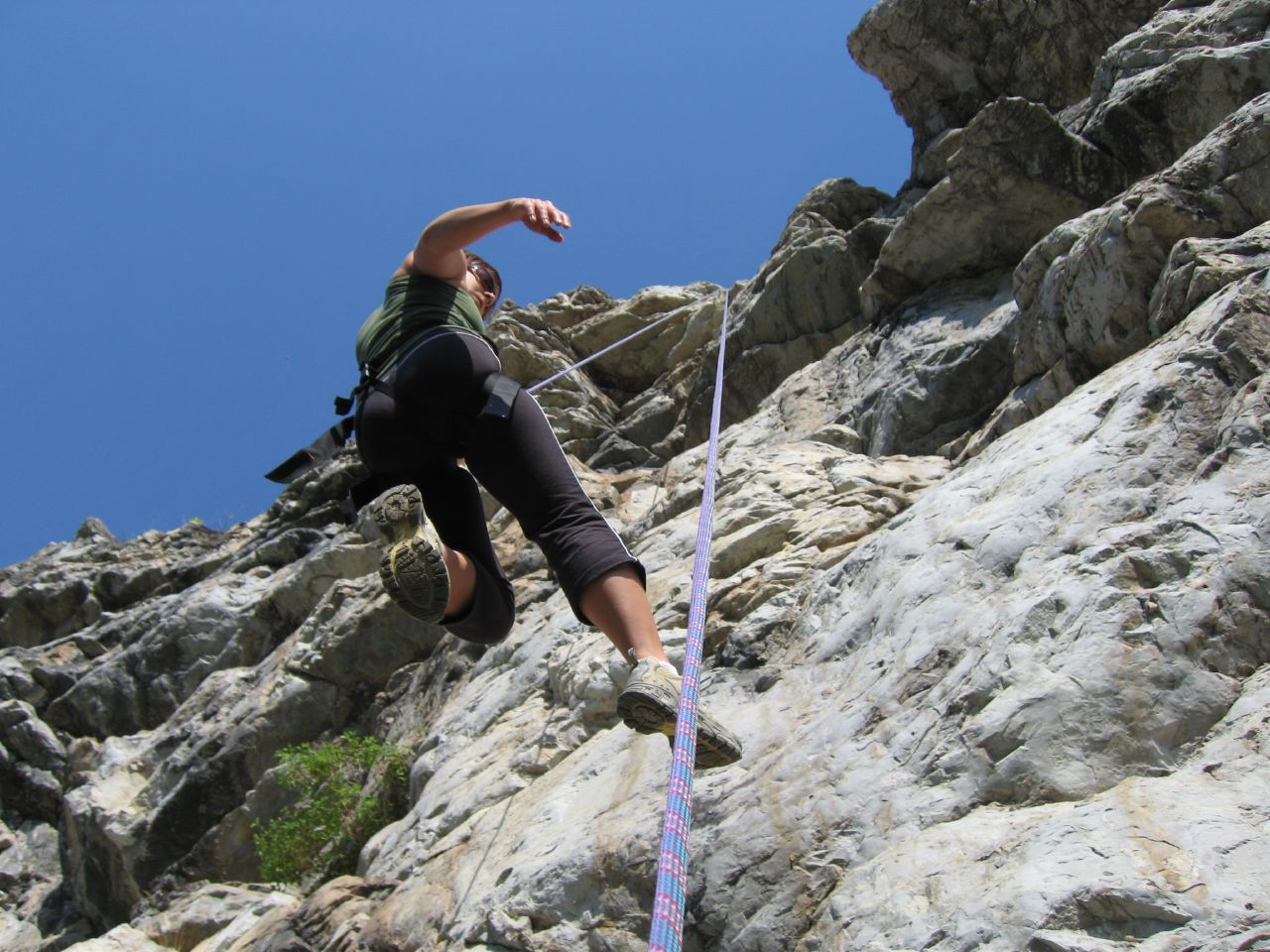person on steep rocky area about to jump