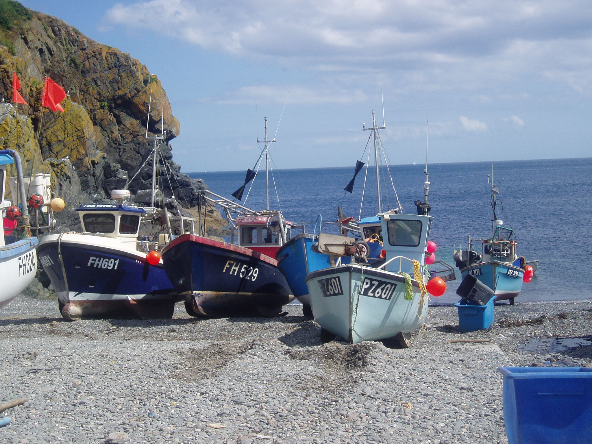 a number of boats on a beach near one another