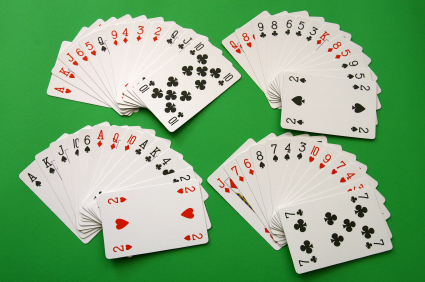 fours and fives of playing cards on a green background