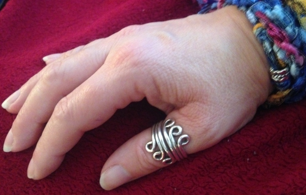 a woman with celets on her ring has a ring in the middle of it