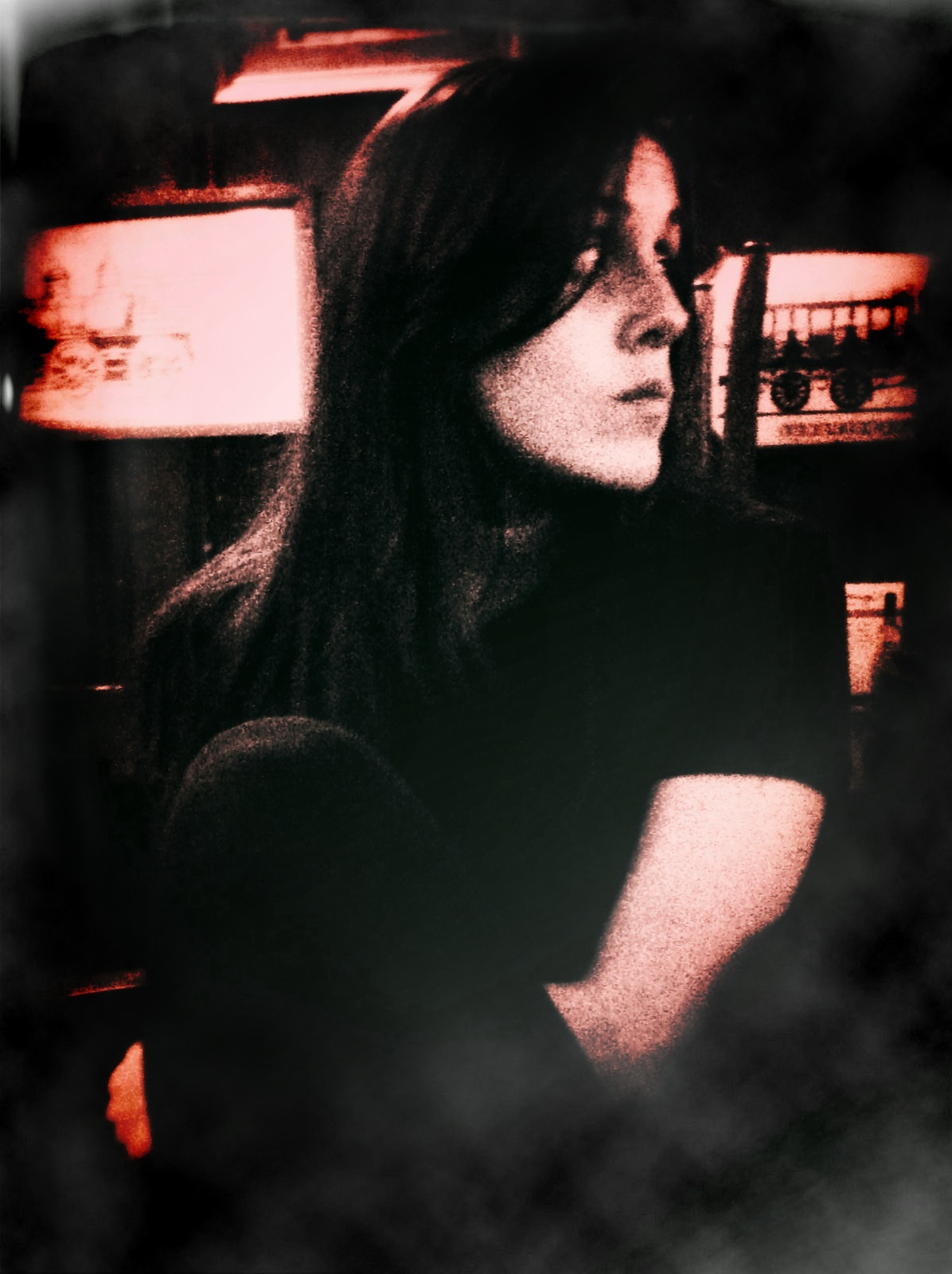 a girl sitting in front of a tv with long black hair