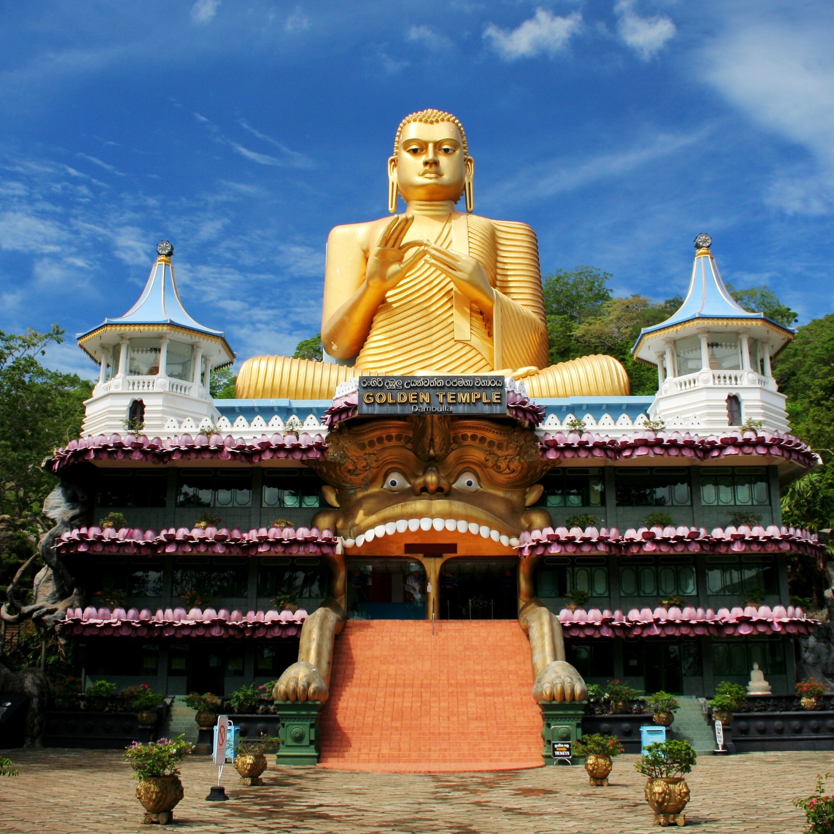 there is a large buddha statue in front of a building
