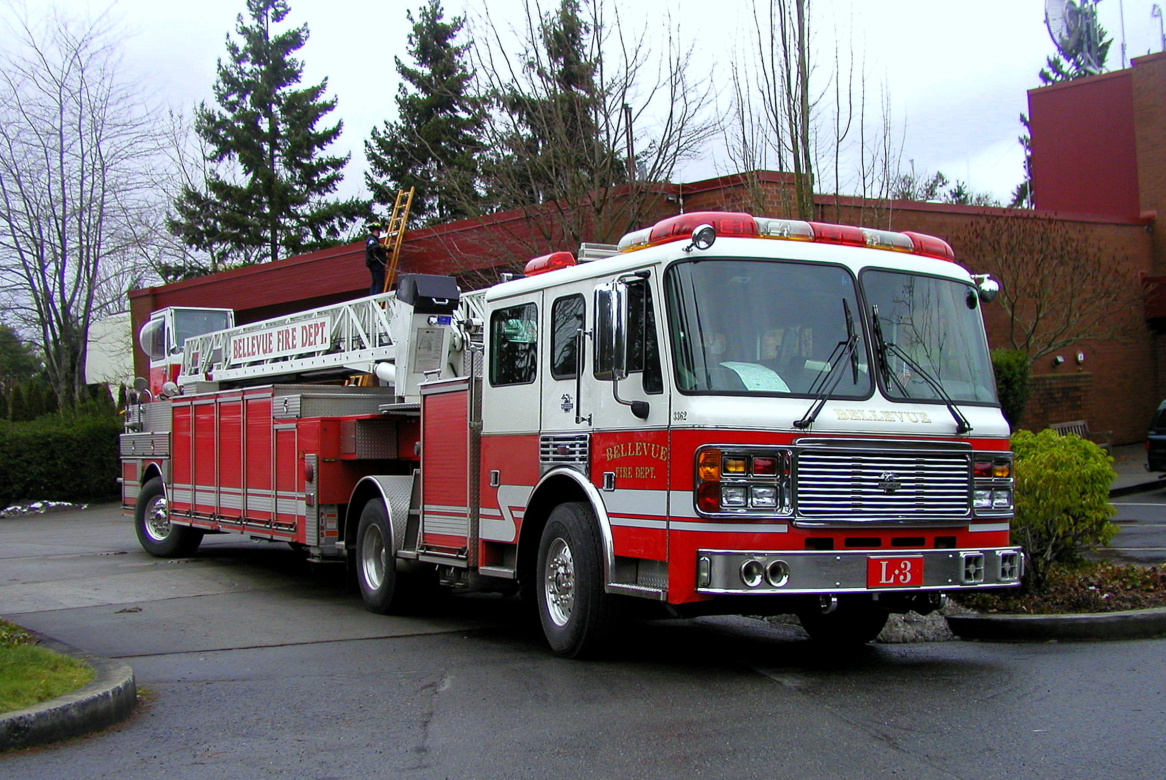 the red and white fire truck is parked outside of the building